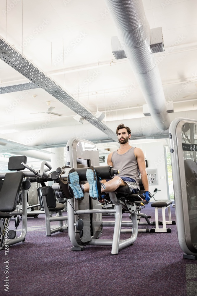 Focused man using weights machine for legs Focused man using weights machine for legs
