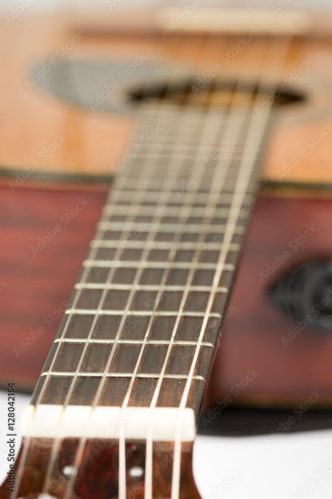 Fototapeta premium Acoustic guitar neck with frets with blurred background