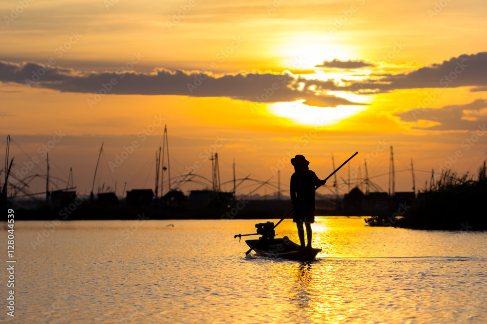 fishermen throwing net fishing in lake on morning sunrise
