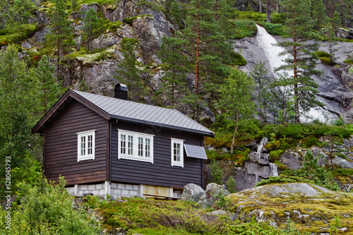 Traditional norwegian wooden house with solar panels in Norway mountains