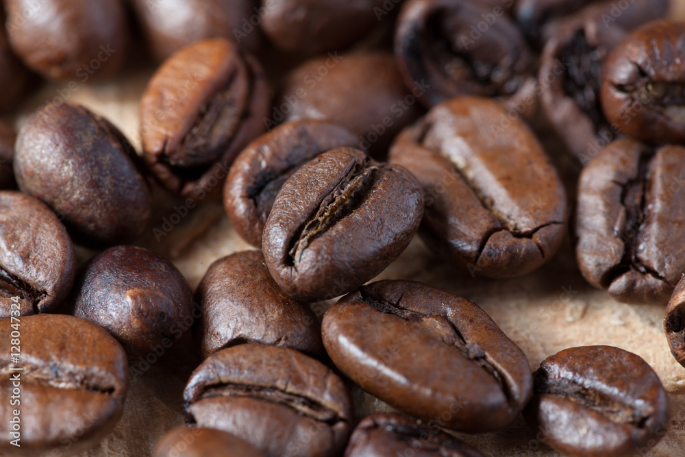 Closeup of coffee beans with focus on one Closeup of coffee beans with focus on one