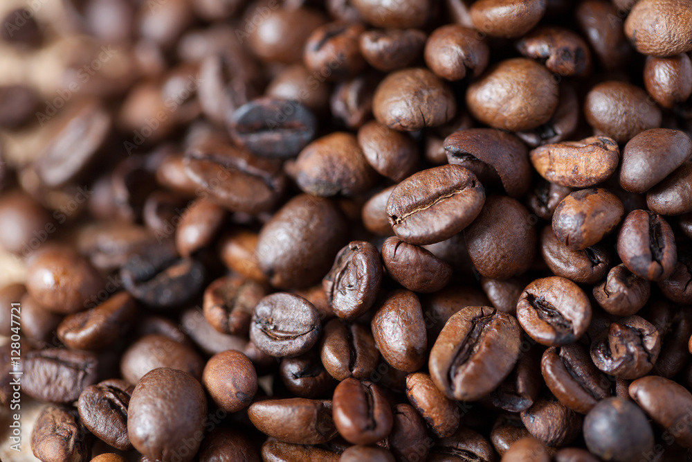 Closeup of coffee beans with focus on one Closeup of coffee beans with focus on one