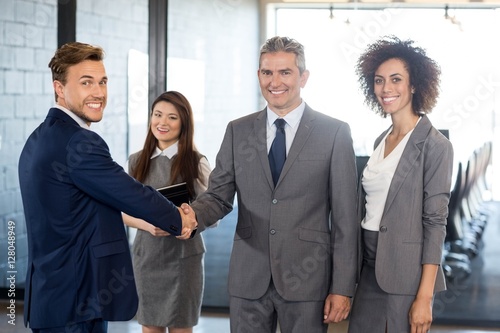 Businessman shaking hands with team