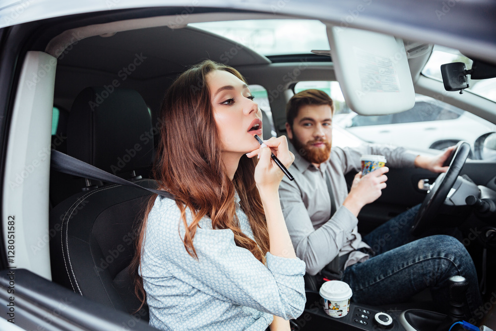 Beauty couple in car with coffee