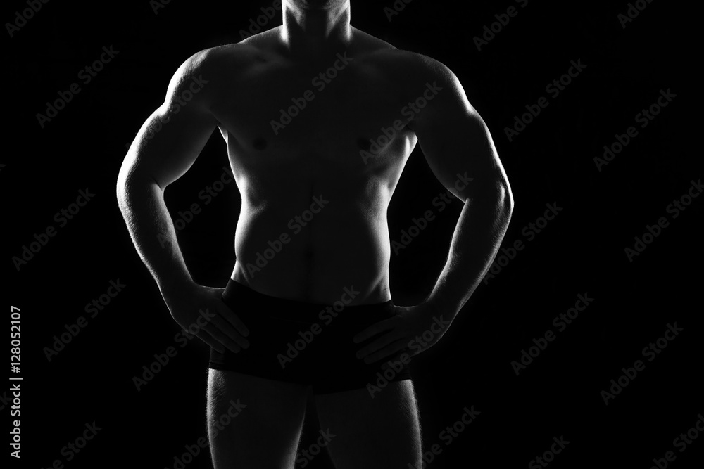 Beautiful and muscular black man's back in dark background Beautiful and muscular black man's back in dark background