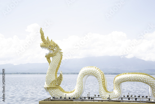 Thai dargon statue in the river.