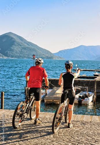People riding bicycles at promenade in Ascona Ticino Switzerland