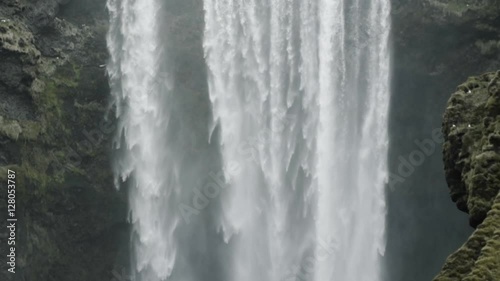 Slow motion tilt down shot of majestic Skogafoss in Iceland
