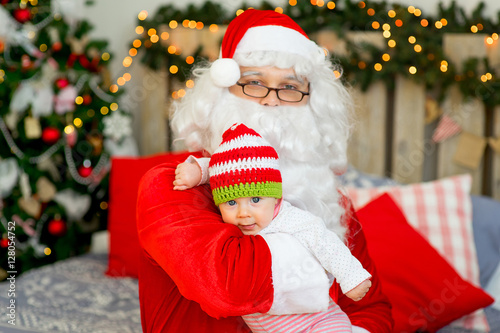 little baby in the arms of Santa Claus