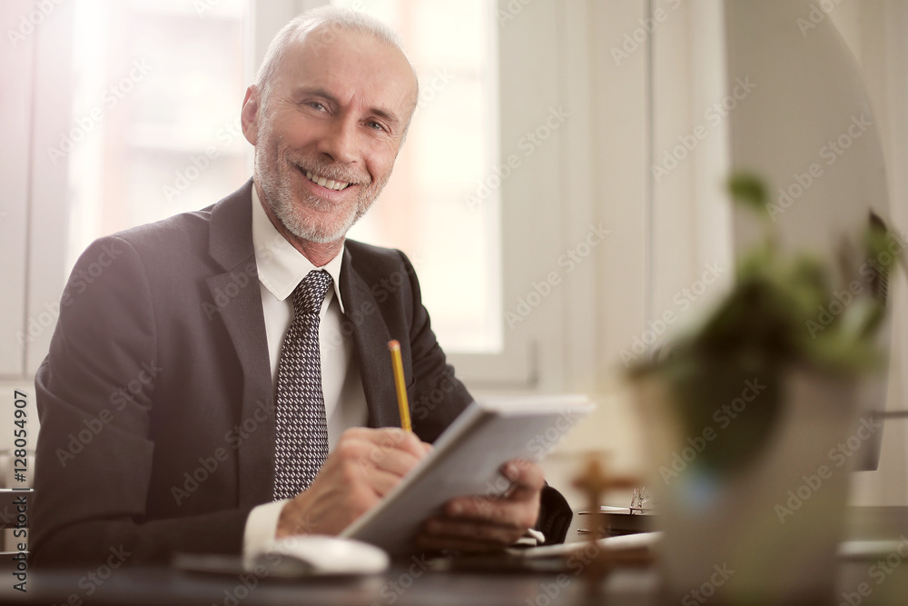 Smiling manager at his desk Smiling manager at his desk