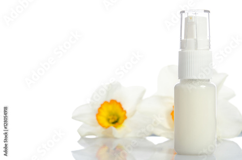bottle with  lotion and flowers isolated on white