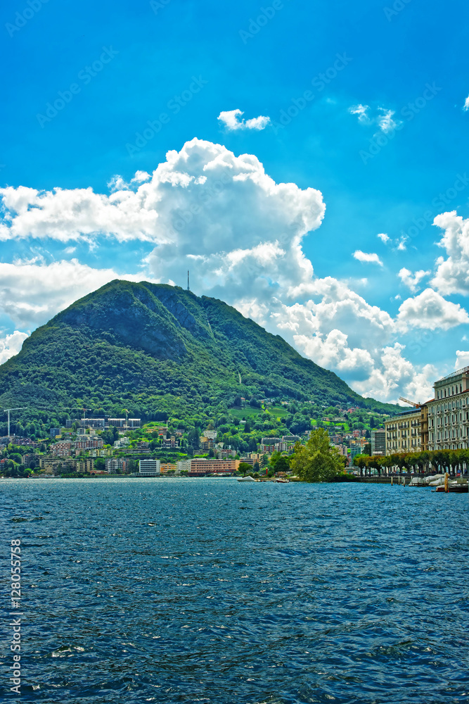 Swiss houses at Lake Lugano and Alps mountains Ticino