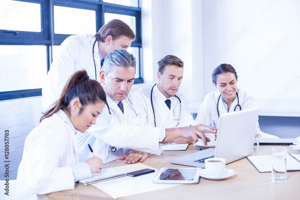 Medical team looking into laptop and having a discussion Medical team looking into laptop and having a discussion