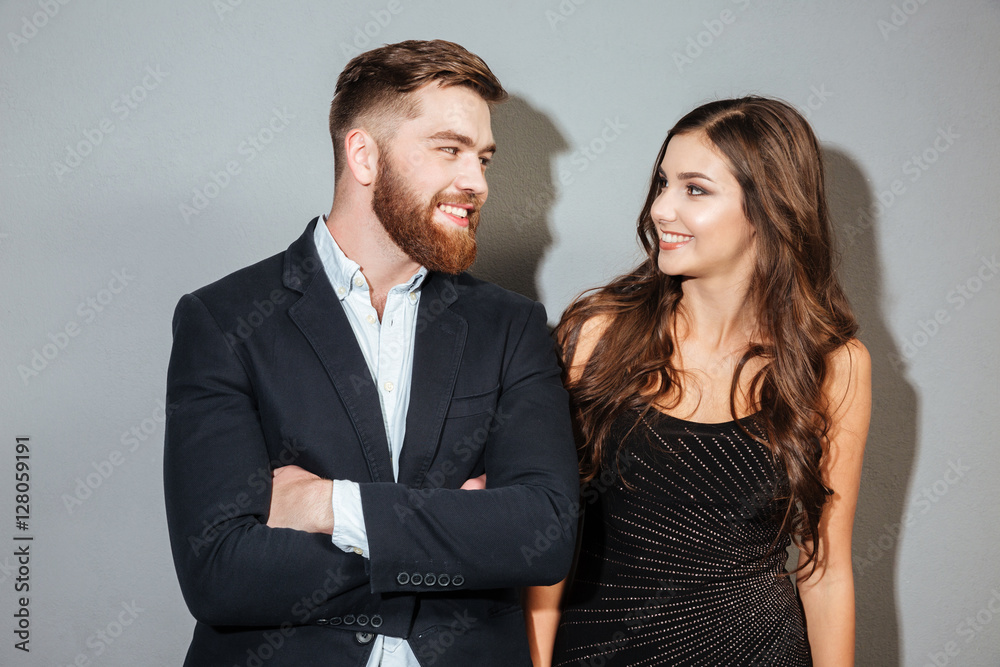 Happy smiling couple in formal wear looking at each other Happy smiling couple in formal wear looking at each other