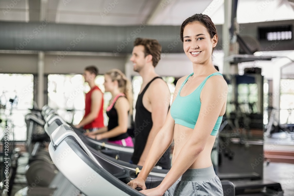 Fit woman running on treadmill