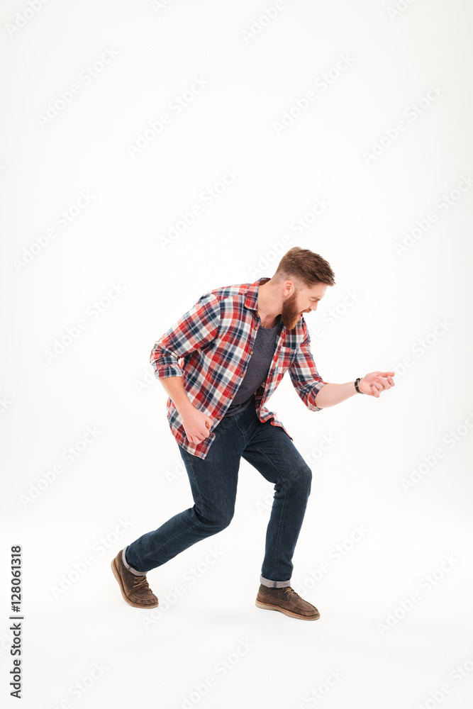 Casual bearded man in plaid shirt playing air guitar Casual bearded man in plaid shirt playing air guitar