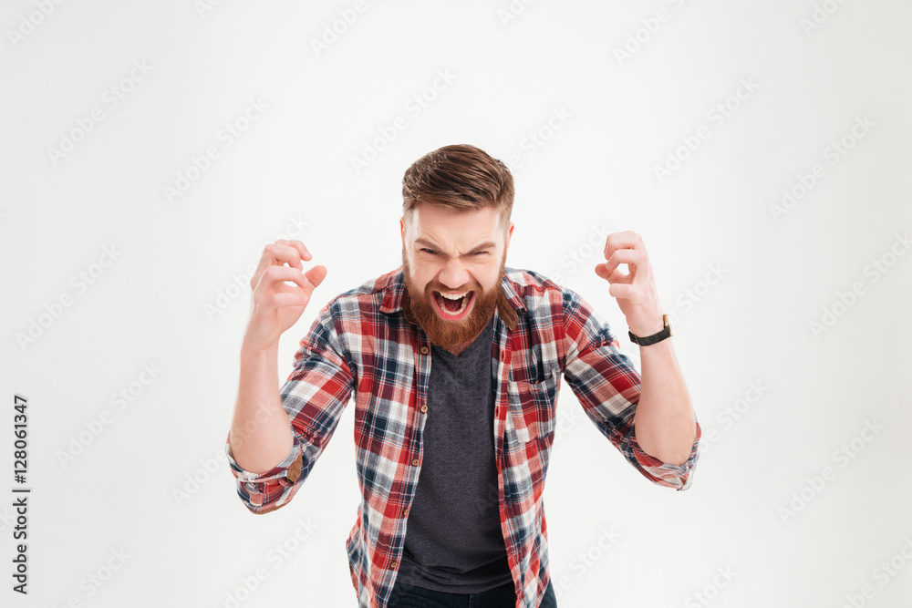 Portrait of a casual angry man screaming with raised arms Portrait of a casual angry man screaming with raised arms