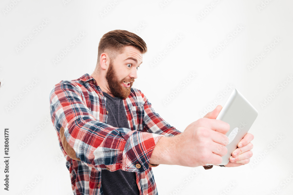 Portrait of a funny bearded man using tablet computer Portrait of a funny bearded man using tablet computer