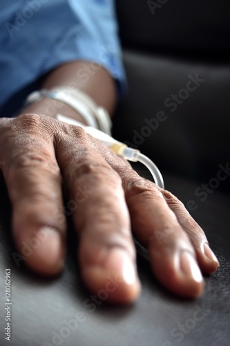 Asia 60 years old, saline iv drip and medical device.