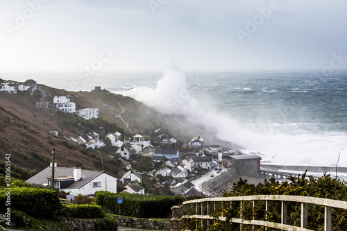 Storm wave breaks over the headland at Sennen Cove