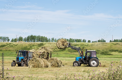 Loading of baled hay front loader