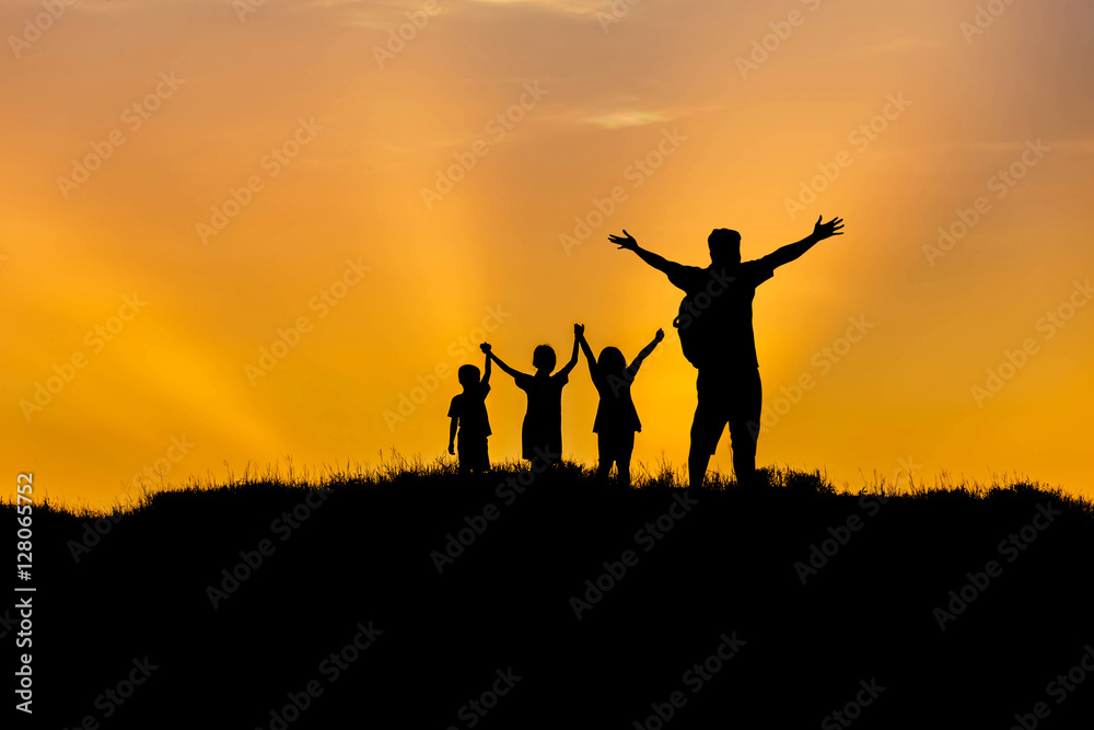 Silhouette father  and children standing raised hands up on sunset  happy time family concept