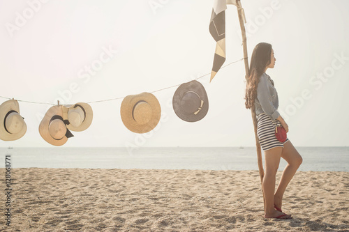 Beautiful girl relaxing outdoor at summer beach with hats.