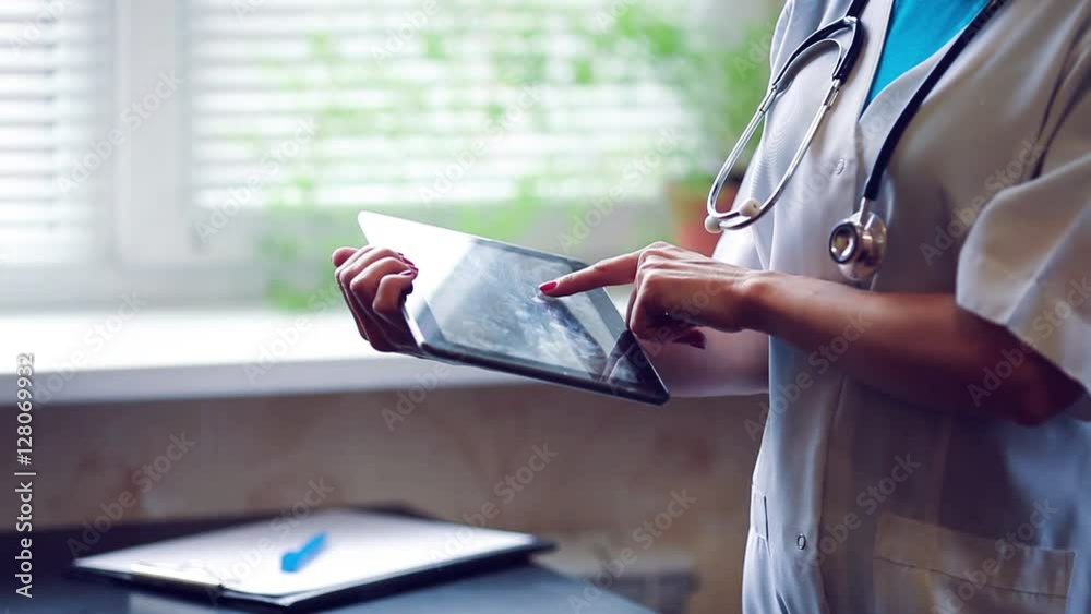 Woman doctor using tablet computer in hospital