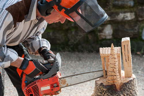 Wallpaper Mural The sculptor carves the wood with the chainsaw Torontodigital.ca