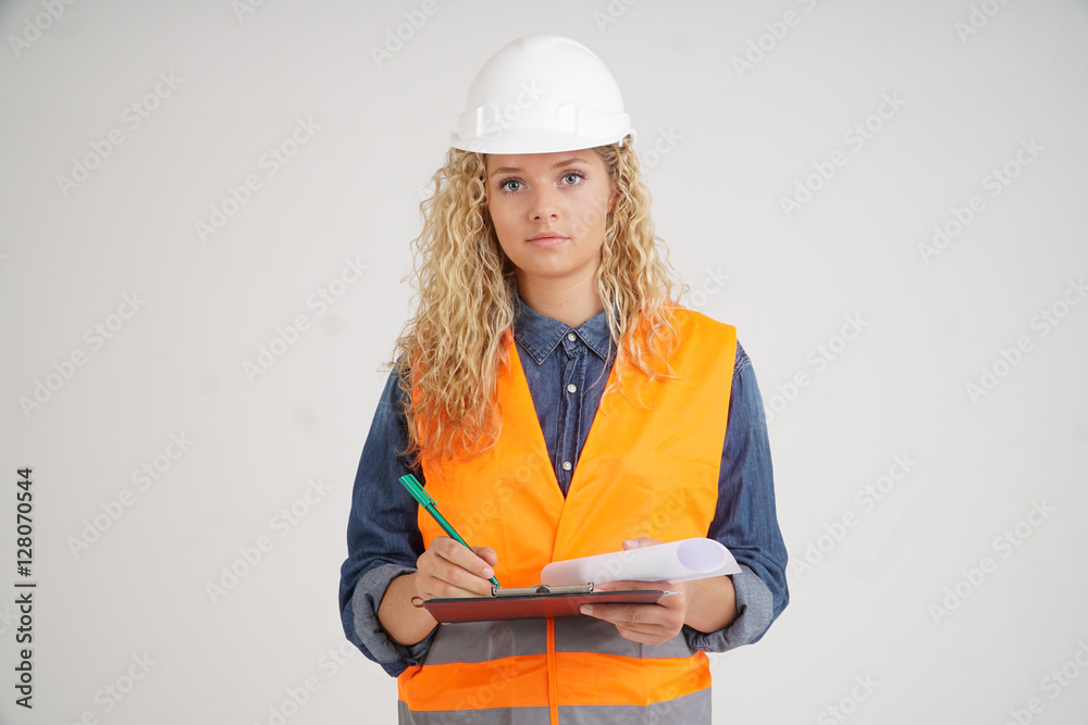 Portrait of female civil engineer, a young blonde girl, with protective clothes and clipboard Photo | Adobe Stock
