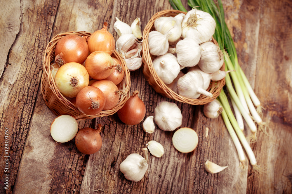 Organic onion, spring onion and garlic on table Organic onion, spring onion and garlic on table