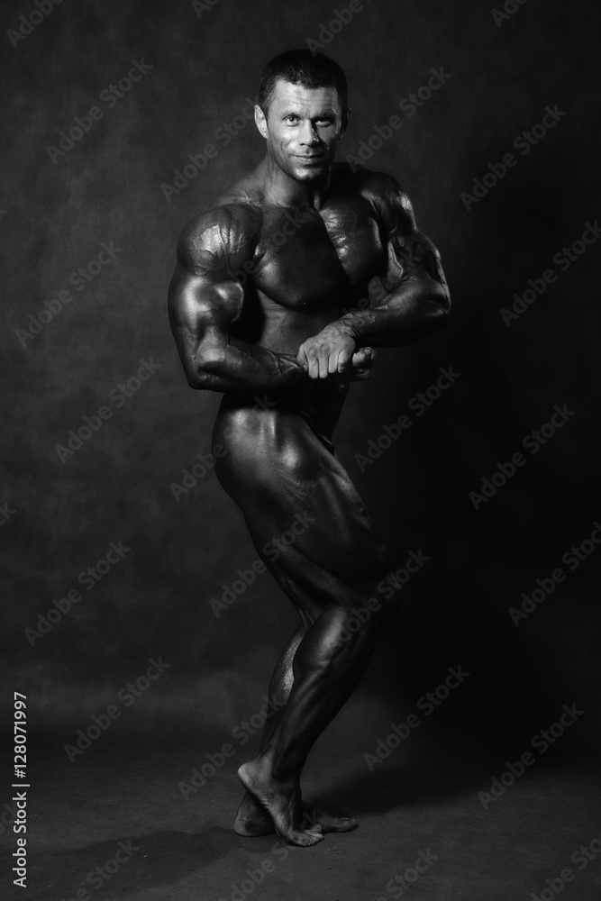 Fototapeta premium Muscular male Bodybuilder posing in studio