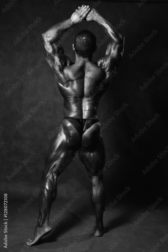 Muscular male Bodybuilder posing in studio Muscular male Bodybuilder posing in studio