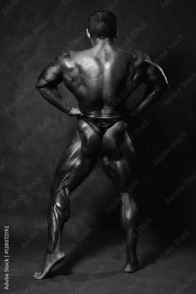 Muscular male Bodybuilder posing in studio Muscular male Bodybuilder posing in studio