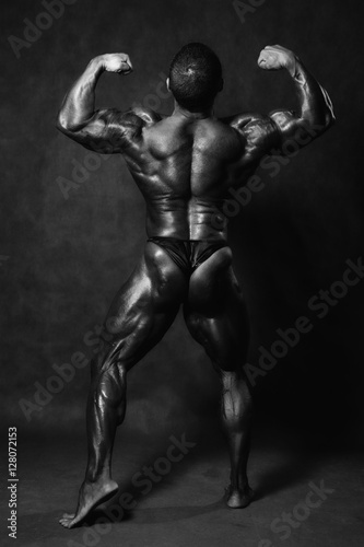 Muscular male Bodybuilder posing in studio