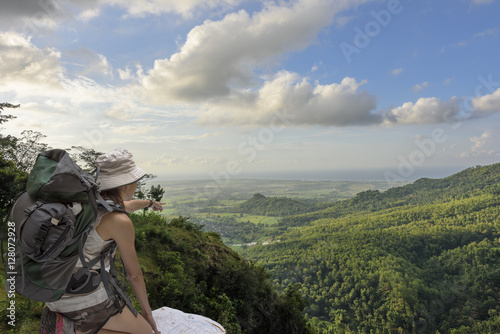 Girl tourist in mountain read the map.