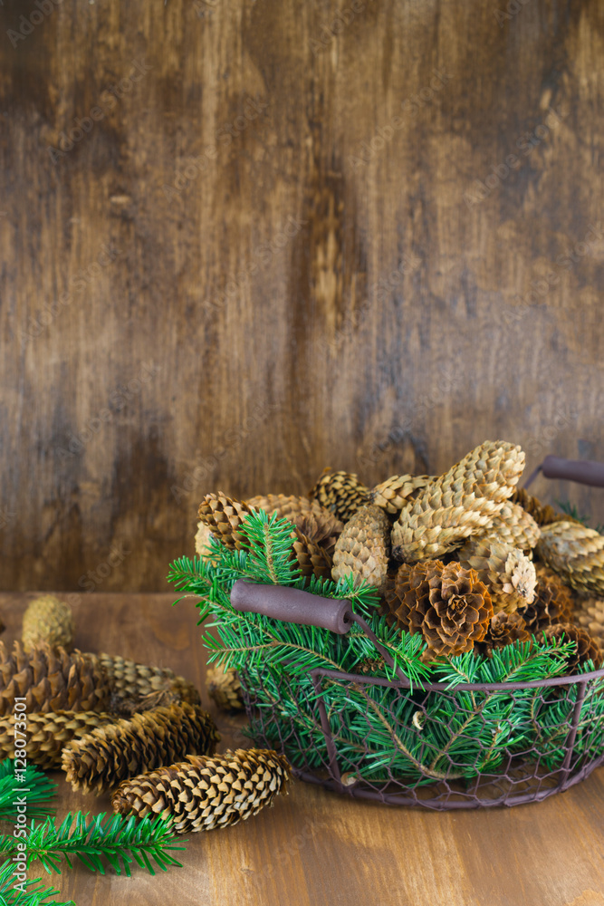 Christmas tree cones in a basket. Vertical, selective focus. Christmas tree cones in a basket. Vertical, selective focus.