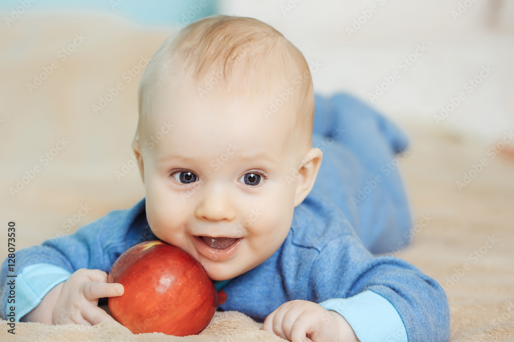 Little happy baby with red apple Little happy baby with red apple