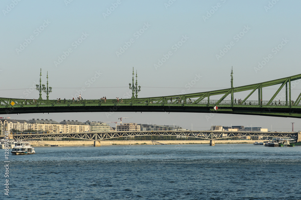 Sailing on the Danube river under Liberty bridge and Petőfi bridge in Budapest Sailing on the Danube river under Liberty bridge and Petőfi bridge in Budapest