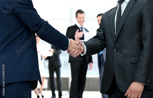 handshake between competitors before the start of business negot