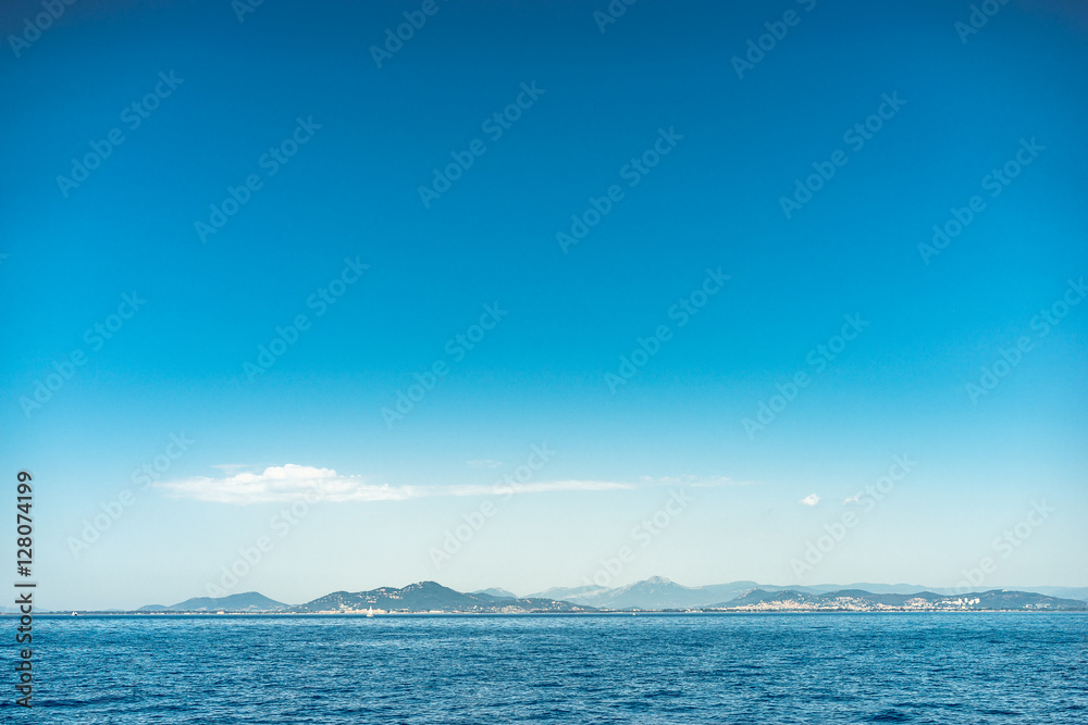 Horizon of Island with Dramatic Blue Sky