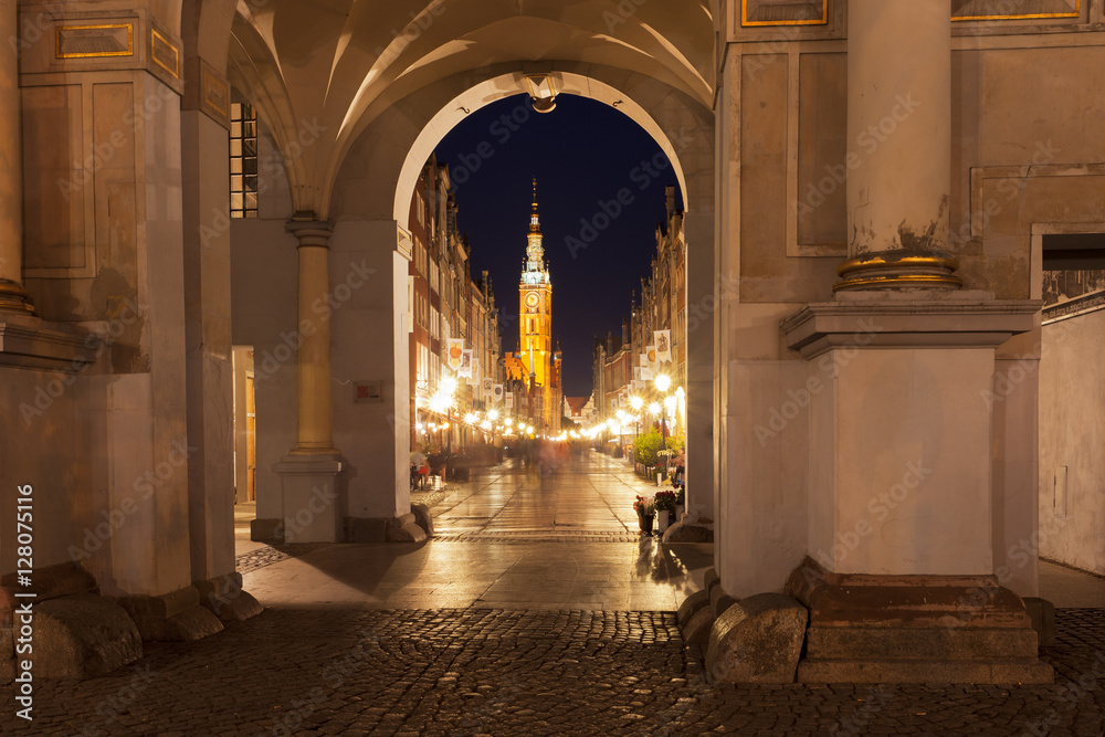 Fototapeta premium Gdansk City Hall clock tower as seen from a tunnel at night 