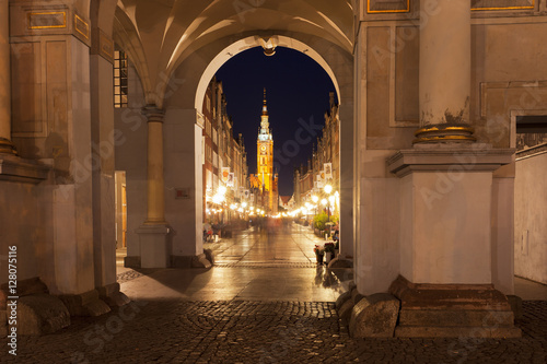 Gdansk City Hall clock tower as seen from a tunnel at night 