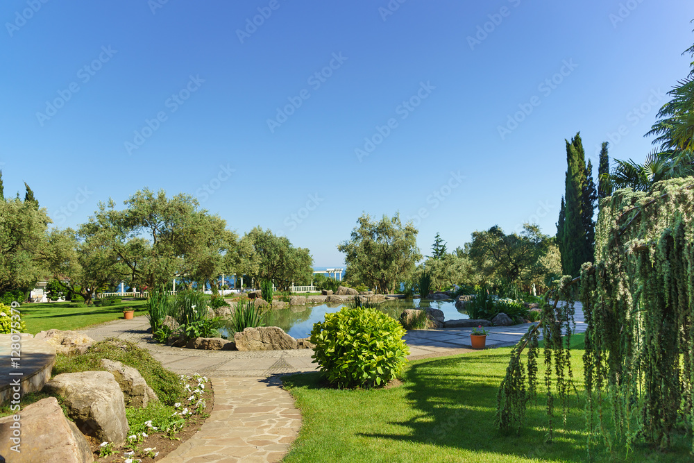 Fototapeta premium Pond and walkway in the Park of Paradise. Partenit, Crimea , Russia