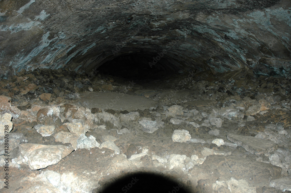 Spooky Hiking Adventure Looking into a Lava Tube Cave in Arizona