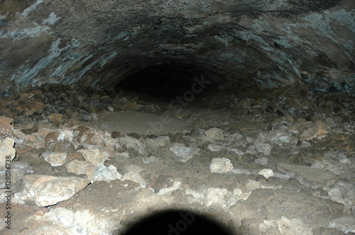 Spooky Hiking Adventure Looking into a Lava Tube Cave in Arizona photo