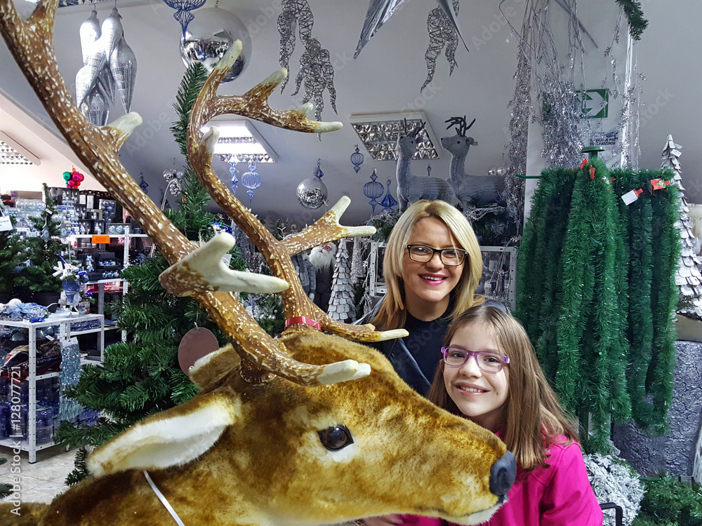 Happy mother and daughter on shopping in store Christmas time