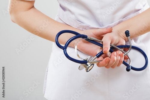 Hands holding stethoscopes