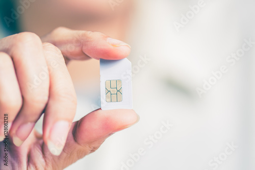 Hand holding sim card, select focus, color effect