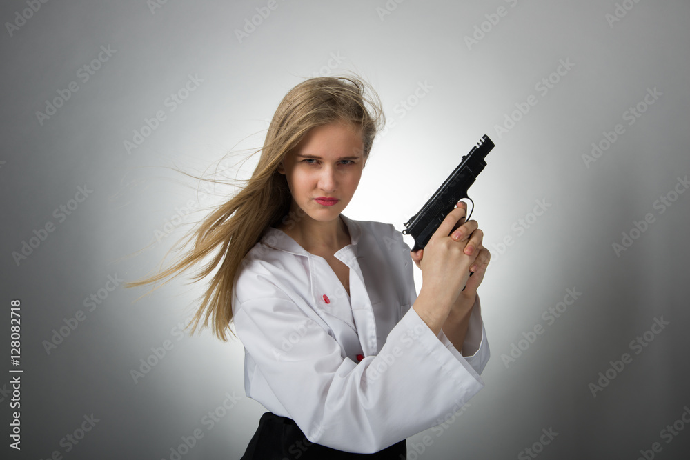Serious Caucasian young woman with long black hair in intimate / with a gun Serious Caucasian young woman with long black hair in intimate / with a gun